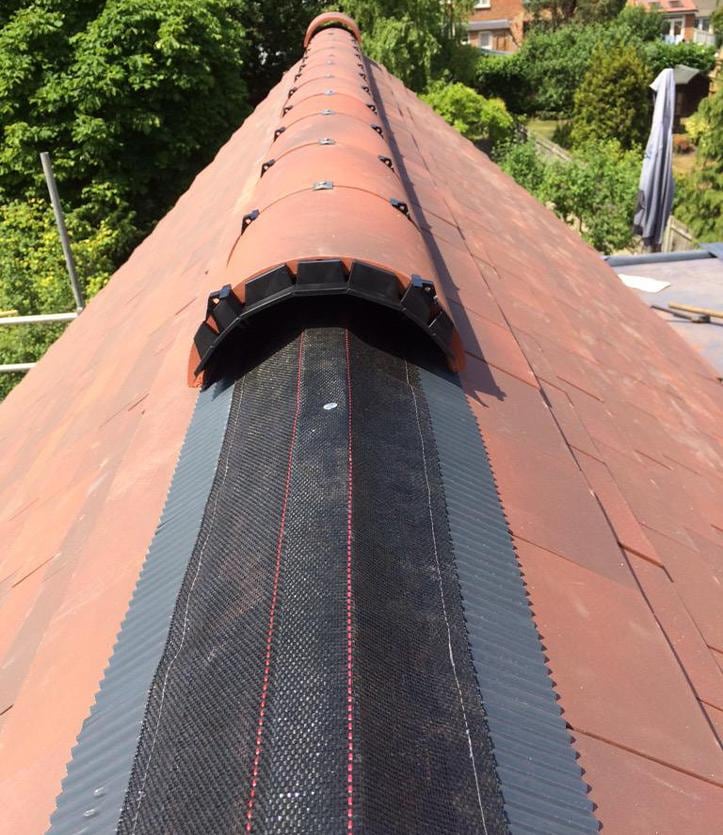 Dry ridge system fitted to a clay tile roof